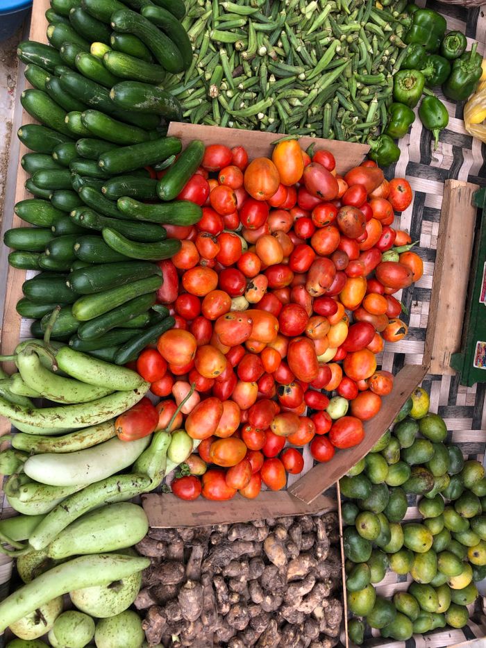 services-04 A vibrant assortment of fresh vegetables displayed at an outdoor market stall, showcasing healthy living.